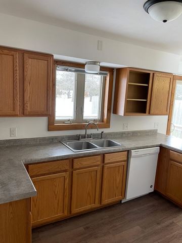 Rothschild apartment for rent - A kitchen with wooden cabinets and a white dishwasher.