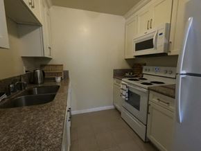 Davis apartment for rent - A kitchen with a stove, oven, and refrigerator.