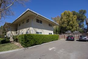 Davis apartment for rent - A house with a grey roof and a grey car parked in front.