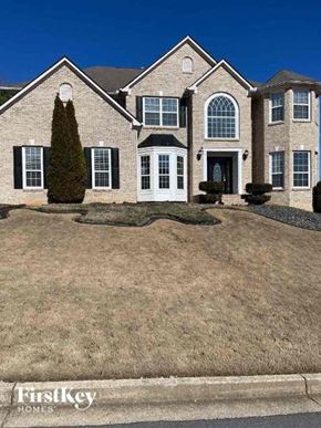 Conyers house for rent - a large house with a lawn in front of it
