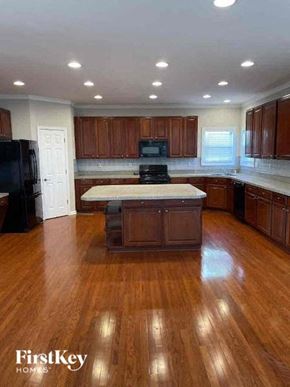 Conyers house for rent - a large kitchen with a center island in the middle