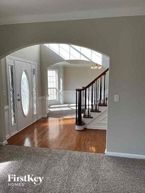Conyers house for rent - an entryway of a house with a door and a staircase