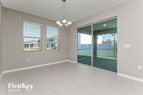 Riverview house for rent - a spacious living room with a sliding glass door to the patio