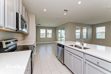 Riverview house for rent - a kitchen with white counter tops and a sink