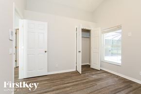 Fort Myers house for rent - a bedroom with white doors and a door to a closet