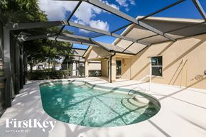 Fort Myers house for rent - a patio with a pool and a house
