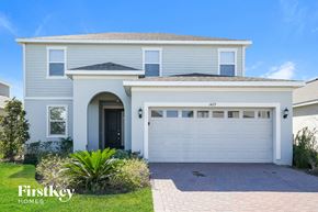 Davenport house for rent - a white house with a garage door in front of it