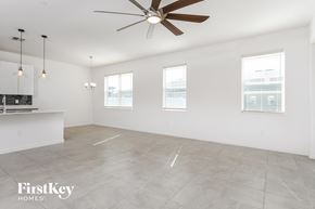 Davenport house for rent - an empty kitchen and living room with a ceiling fan