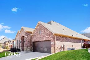 Aledo house for rent - a brick house with a garage and a lawn