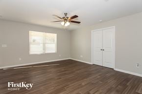 Kernersville house for rent - A room with a ceiling fan and wooden flooring.