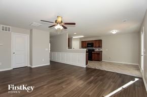 Kernersville house for rent - A spacious room with a ceiling fan and wooden flooring.