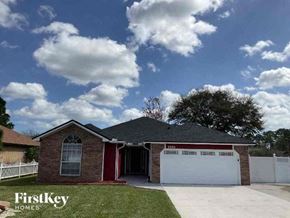 Jacksonville house for rent - A house with a red garage door is for sale.