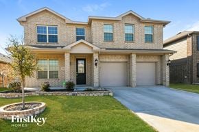Fort Worth house for rent - a house with two garage doors and a sidewalk in front of it