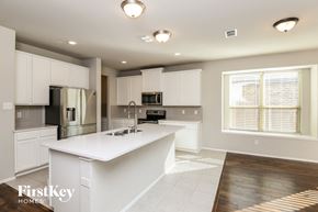 Fort Worth house for rent - a large kitchen with white cabinets and a white counter top