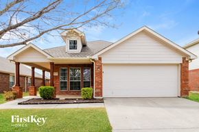 Crossroads house for rent - a home with a white garage door and a porch