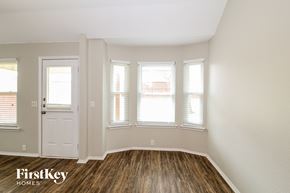 Crossroads house for rent - the living room of a home with wood floors and a white door