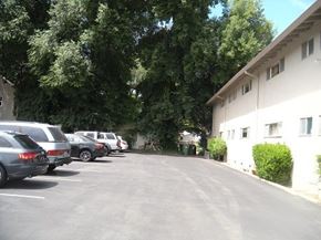 Davis apartment for rent - a parking lot filled with cars next to a building