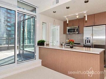 Vancouver apartment for rent - A kitchen with a refrigerator, microwave, and oven.