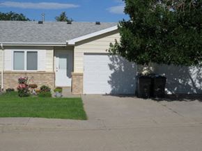 Cheyenne townhouse for rent - a house with a white garage door and a driveway