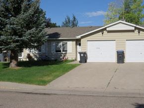 Cheyenne apartment for rent - a yellow house with a white garage door