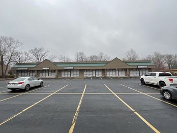 Bella Vista apartment for rent - A parking lot with a building in the background and cars parked in the spaces.
