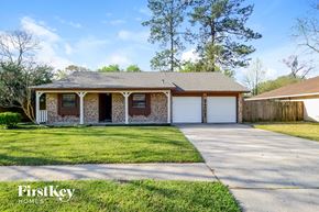 Spring house for rent - A house with a brown roof and a white garage door is for sale.