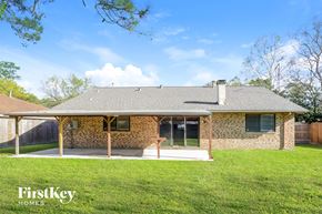 Spring house for rent - A house with a brown stone exterior and a grey roof is for sale.