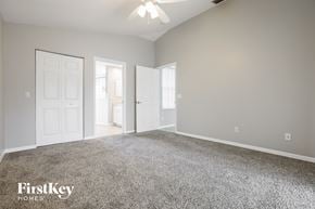 Rotonda West house for rent - a bedroom with a carpeted floor and a white door