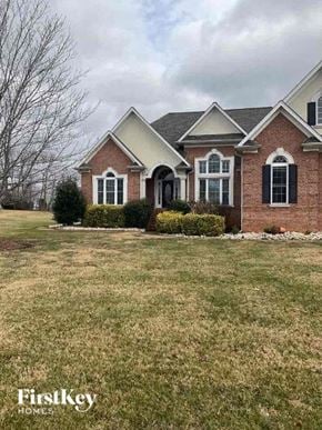Statesville house for rent - a brick house with a yard and a lawn