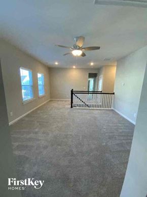 Summerville house for rent - a large empty living room with a ceiling fan