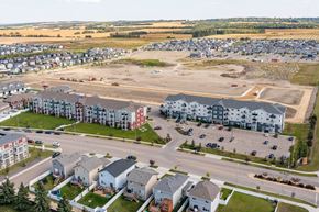 Red Deer apartment for rent - A large parking lot is surrounded by apartment buildings.