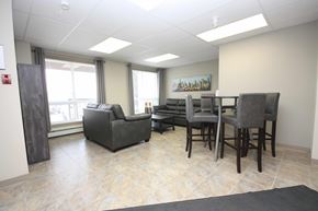 Red Deer apartment for rent - A room with a couch, chairs, and a table.