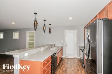 St Charles house for rent - A kitchen with a white counter top and wooden floors.