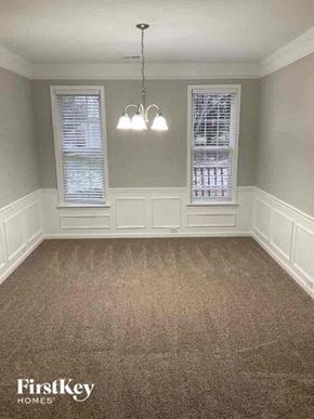 Charlotte house for rent - a empty room with two windows and a carpet