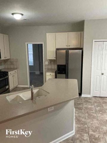 Charlotte house for rent - a kitchen with a sink and a refrigerator