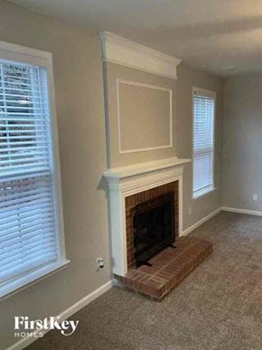 Charlotte house for rent - a living room with a fireplace and a window
