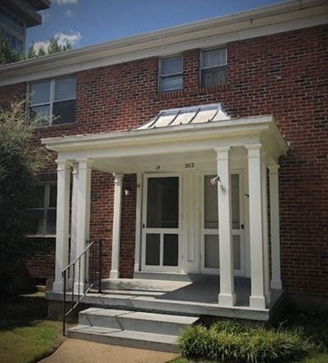 Memphis apartment for rent - A red brick house with a white door and windows.