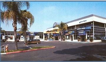 San Diego apartment for rent - a parking lot with a building and palm trees