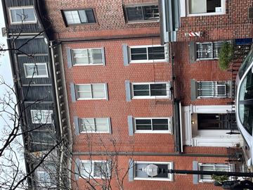 Boston apartment for rent - A tall red brick building with many windows.