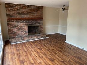 Cedartown apartment for rent - a living room with a brick fireplace and a wooden floor