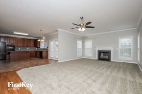 High Point house for rent - A spacious living room with a fireplace and a television.