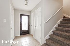 San Antonio house for rent - A staircase with a carpeted runner and a white door on the right.