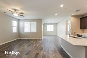 Maricopa house for rent - an empty kitchen and living room with a ceiling fan