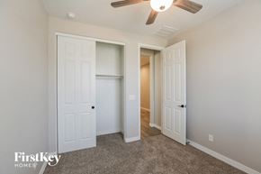 Maricopa house for rent - a bedroom with two closets and a ceiling fan