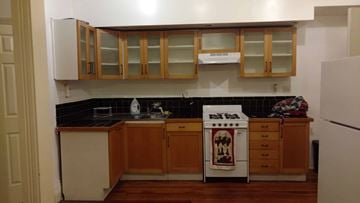 Easton apartment for rent - A kitchen with wooden cabinets and a white refrigerator.