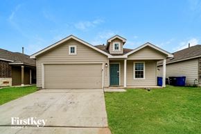 San Antonio house for rent - a beige house with a green lawn and a driveway