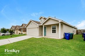 San Antonio house for rent - a beige house with a yard and a driveway