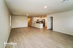 San Antonio house for rent - an empty living room and kitchen with wood flooring