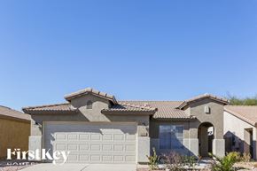 Maricopa house for rent - A house with a garage door and a sign that says "Firstkey" on it.