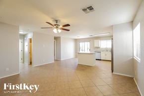 Maricopa house for rent - A spacious room with a ceiling fan and tiled flooring.